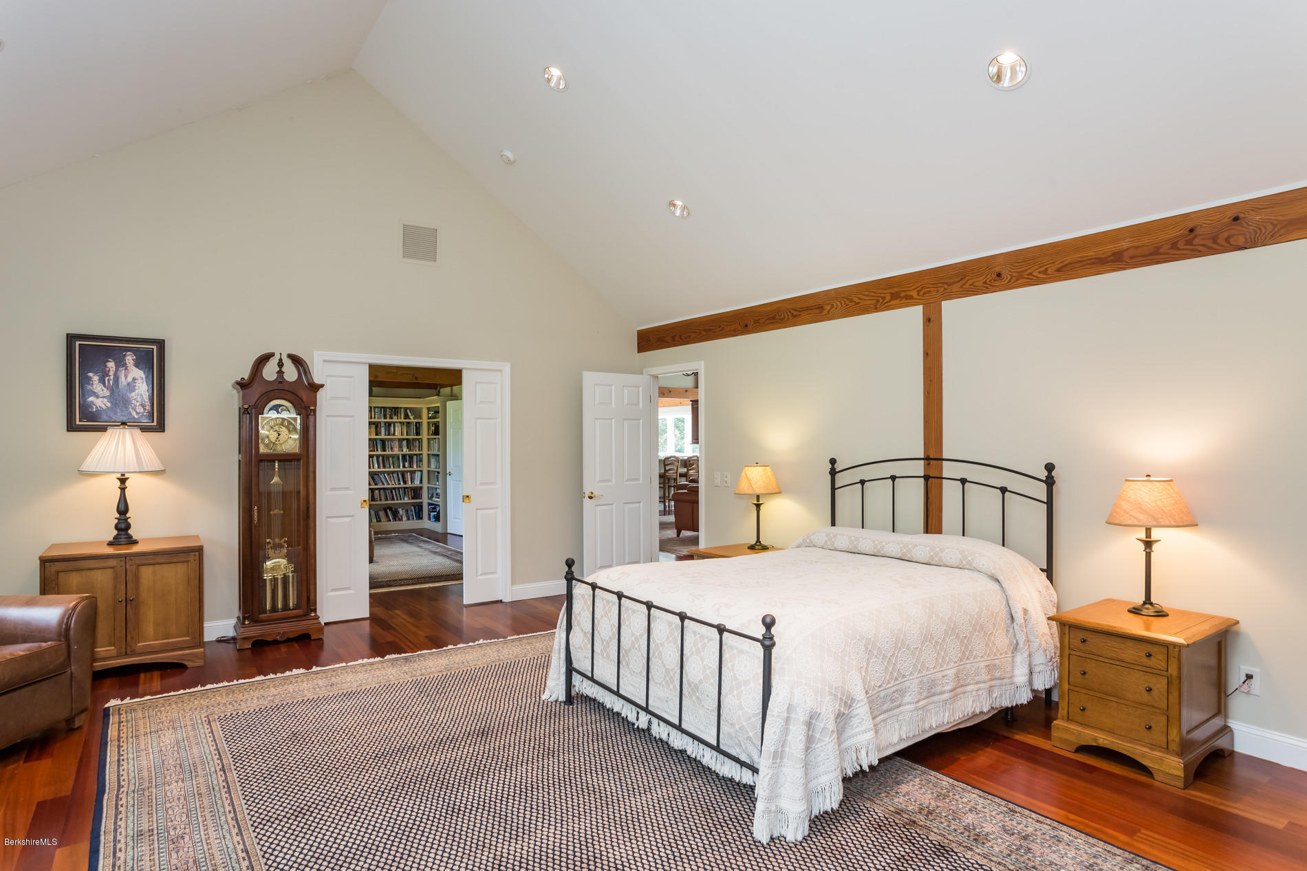 305 Moreau Road Tolland, MA 01034 - Photo 39 of 49 a bedroom with a large bed and a chandelier
