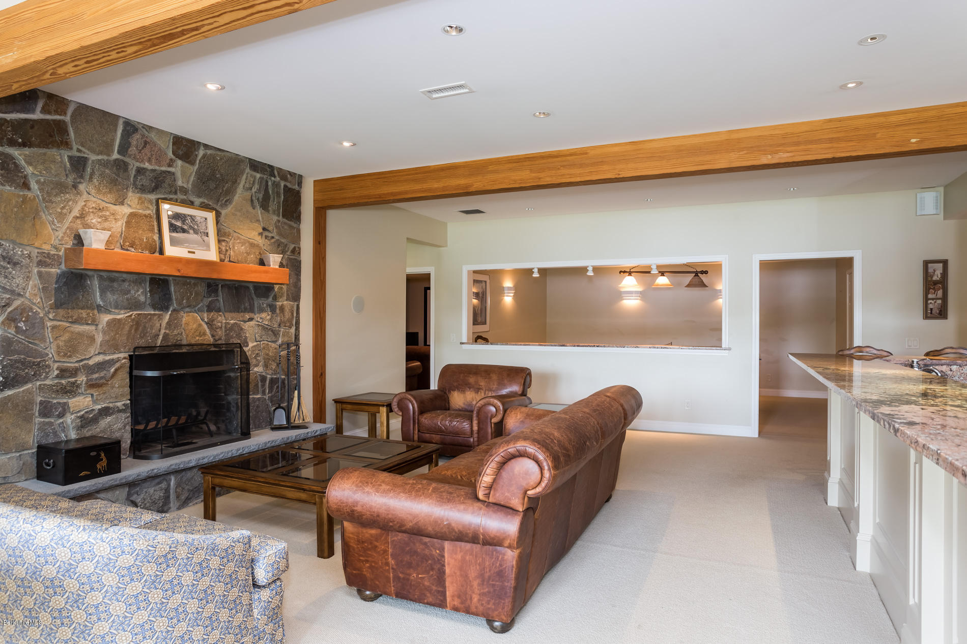 305 Moreau Road Tolland, MA 01034 - Photo 45 of 49 a living room with furniture a flat screen tv and a fireplace