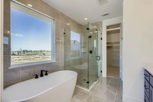 a bathroom with a granite countertop tub shower view and a sink