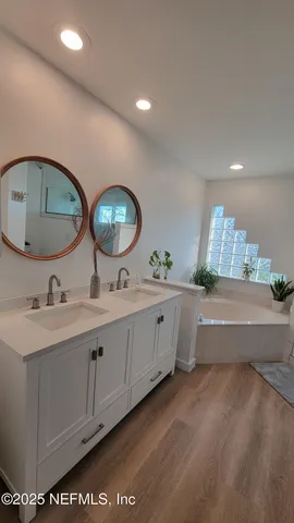 a bathroom with a double vanity sink and a mirror