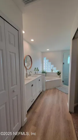 a view of a kitchen with window and wooden floor