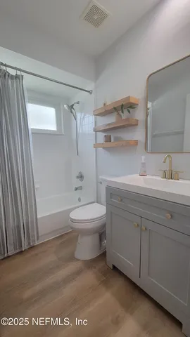 a bathroom with a toilet a sink and shower