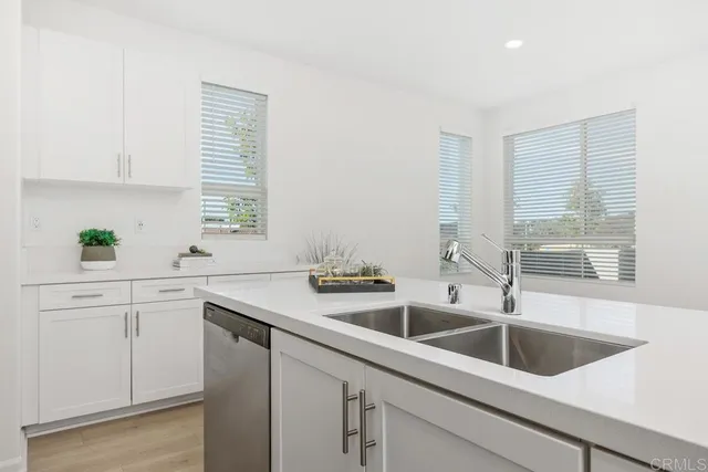 a kitchen with sink and large window