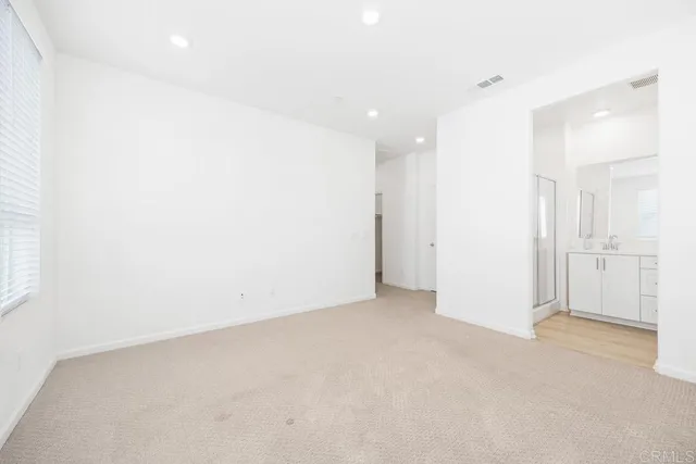 a bathroom with a double vanity sink mirror and shower