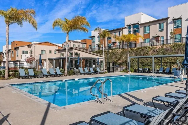 a view of a patio with a table chairs and a backyard
