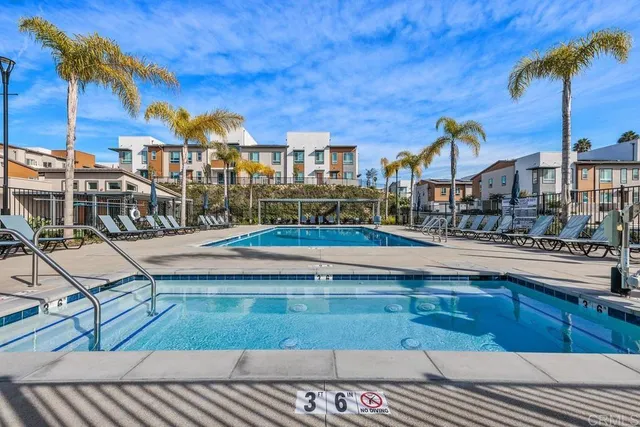 a view of a chairs and table in patio with a lake view