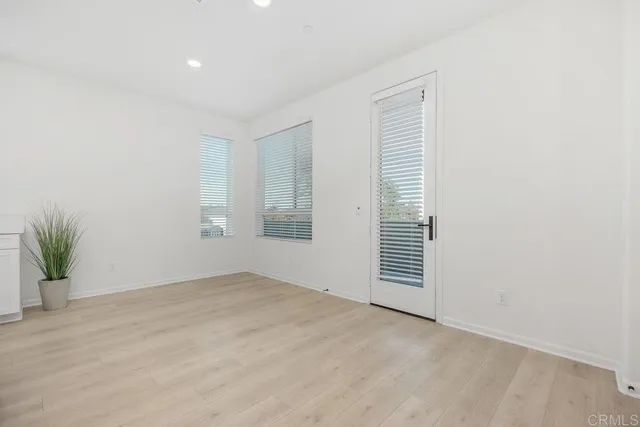 an empty room with windows and entrance