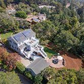 an aerial view of a house with outdoor space and street view