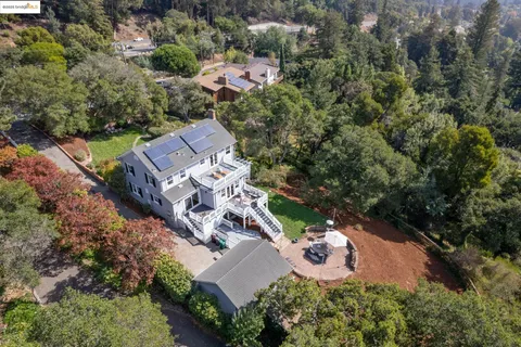 an aerial view of a house with outdoor space and street view
