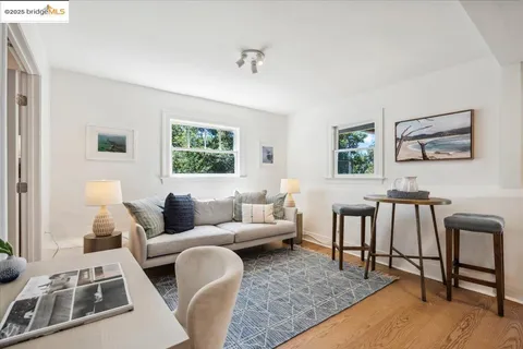 a view of a patio with dining table and chairs with a barbeque grill and plants