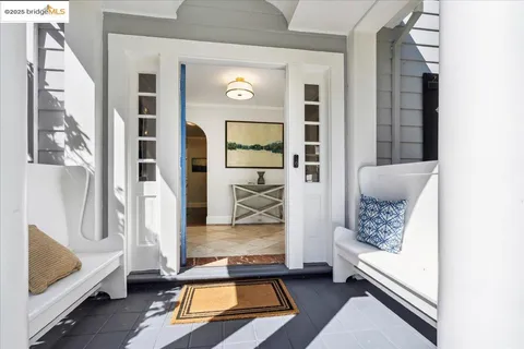 a living room with chairs and a table with wooden floor