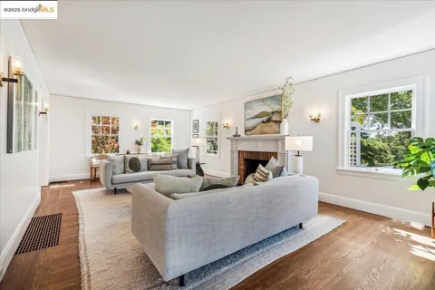 a dining room with furniture a chandelier and wooden floor