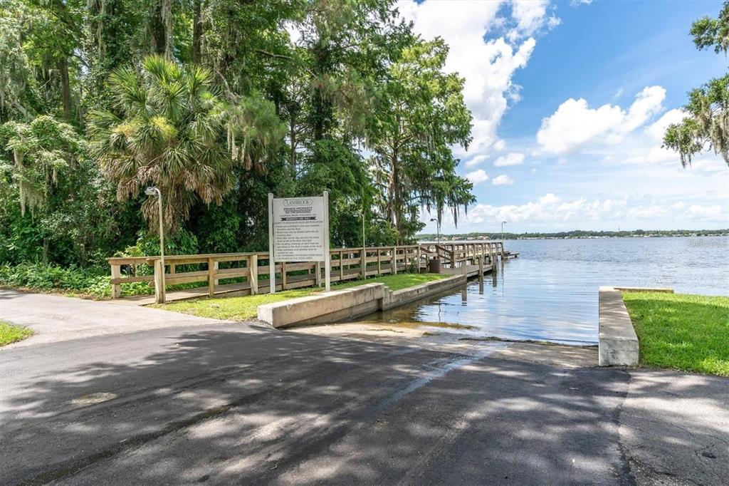 4324 Auston Way Palm Harbor, FL 34685 - Photo 47 of 54 a view of a swimming pool with an outdoor seating and a yard