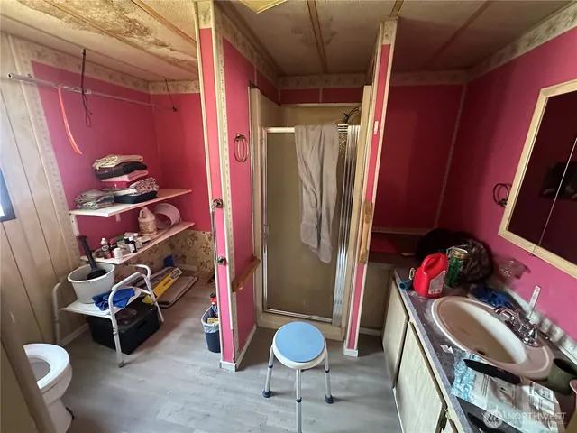 a view of a room with gym equipment and lots of wooden floor