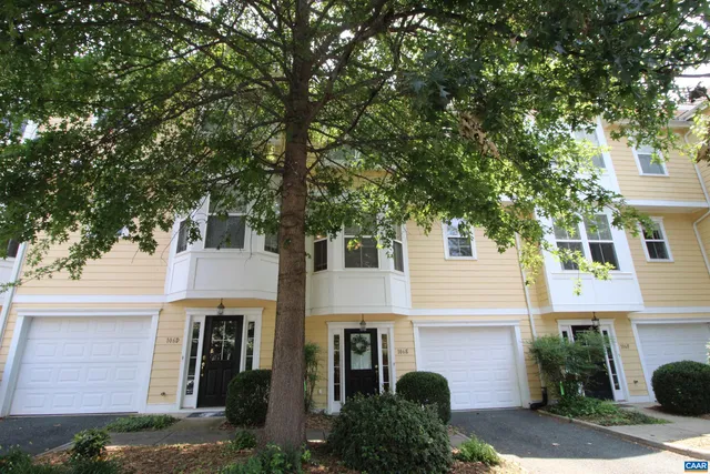 a front view of a house with plants