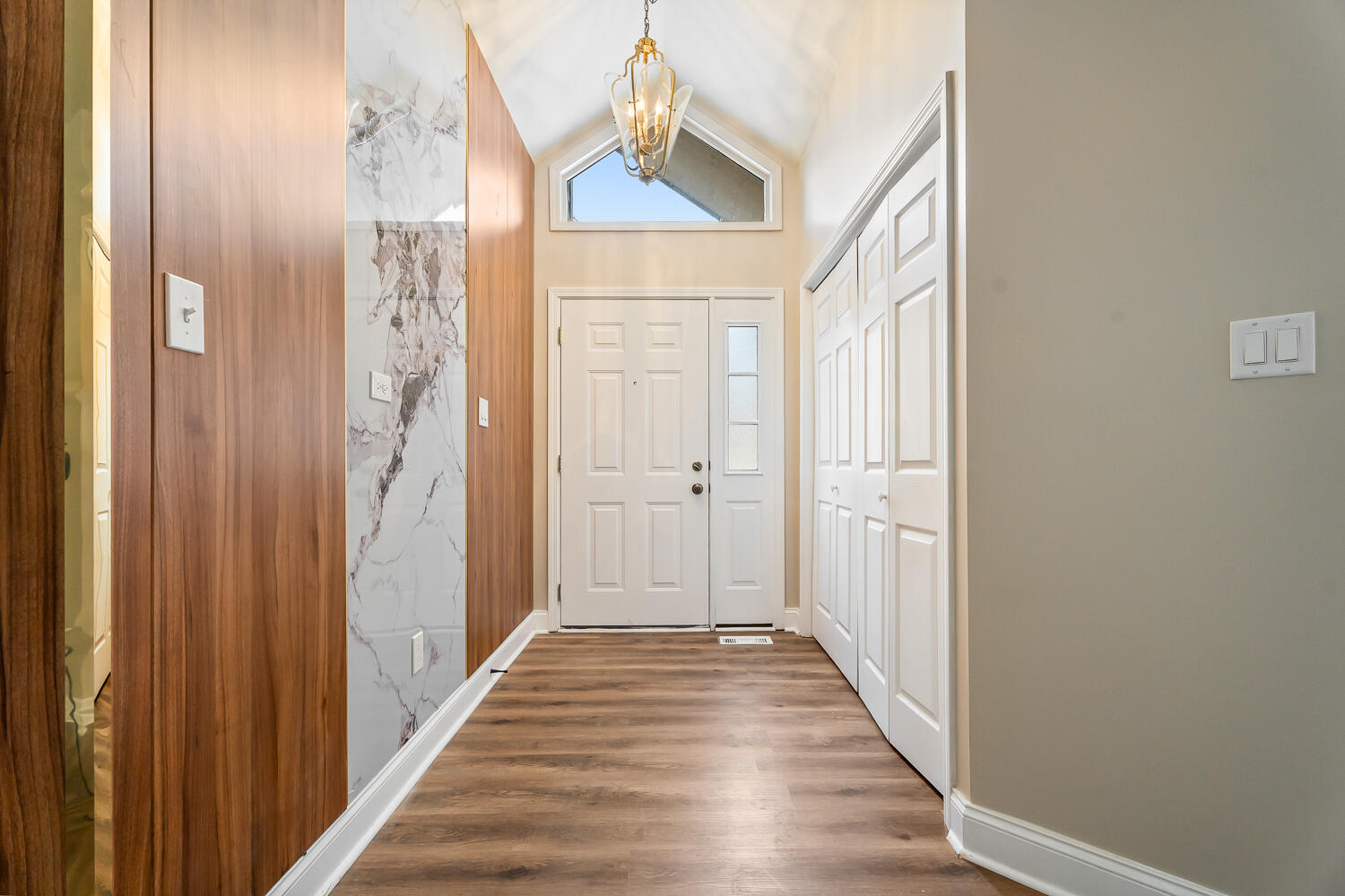 902 Cornwallis Lane Munster, IN 46321 - Photo 3 of 59 a view of a hallway with wooden floor and staircase