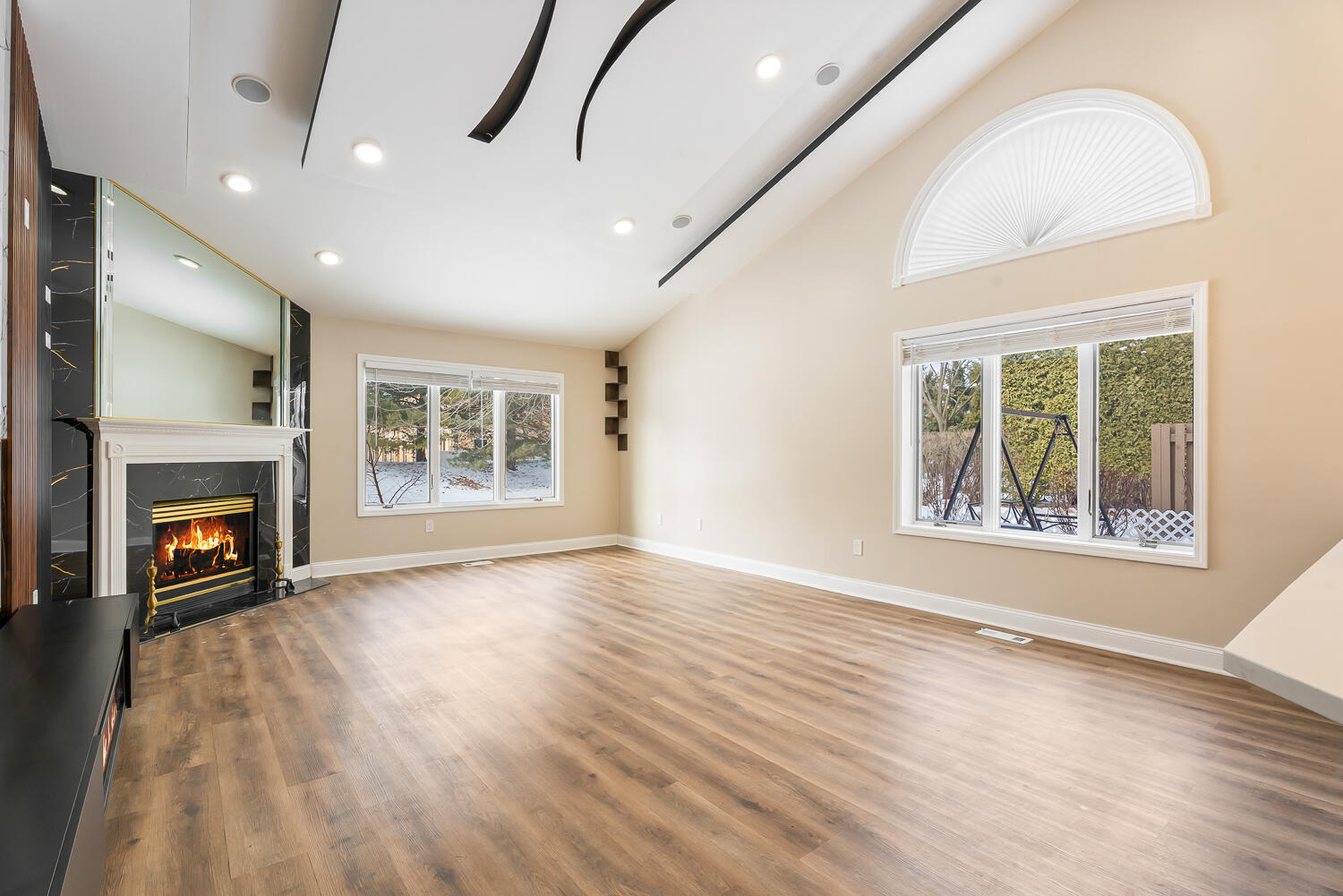 902 Cornwallis Lane Munster, IN 46321 - Photo 6 of 59 an empty room with windows fireplace and wooden floor