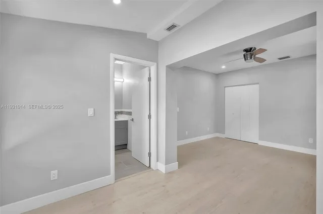 a white toilet sitting next to a bathroom sink