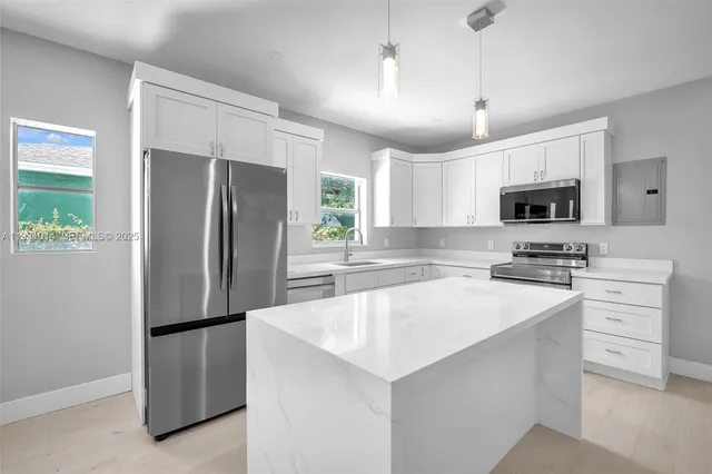 a kitchen with a refrigerator sink and microwave