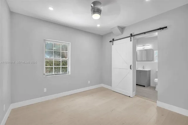a bathroom with a sink mirror and toilet