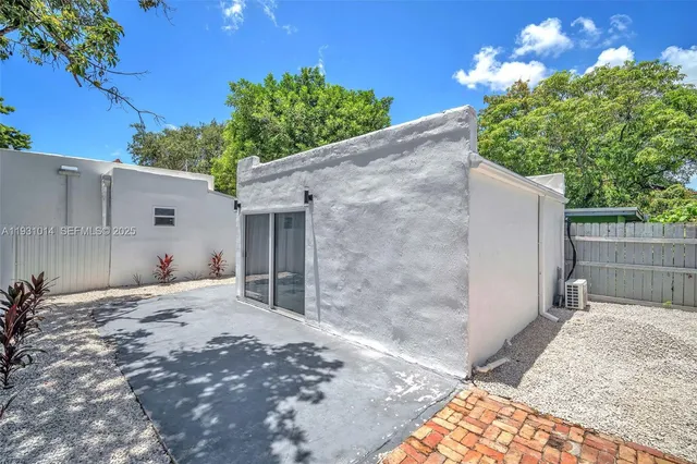 a bedroom with a bed and a refrigerator