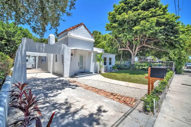 a large white kitchen with cabinets and stainless steel appliances