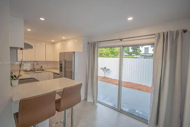 a kitchen with cabinets stainless steel appliances and a counter space