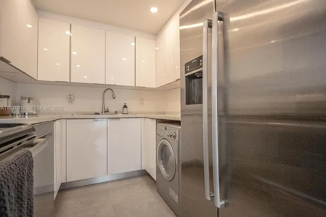 a kitchen that has a lot of cabinets in it and appliances