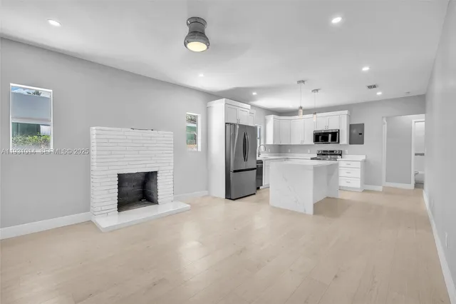 a large white kitchen with cabinets and stainless steel appliances