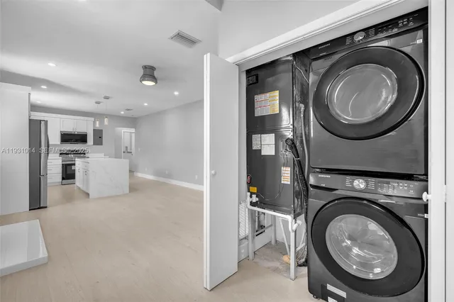 an empty room with fan and windows