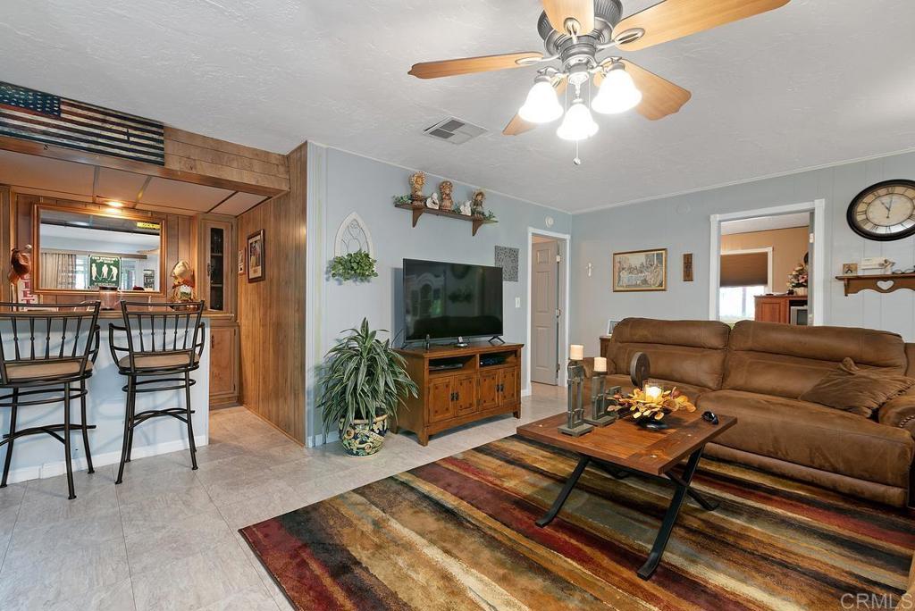 18218 Paradise Mountain Road Valley Center, CA 92082 - Photo 13 of 37 a living room with furniture and a flat screen tv