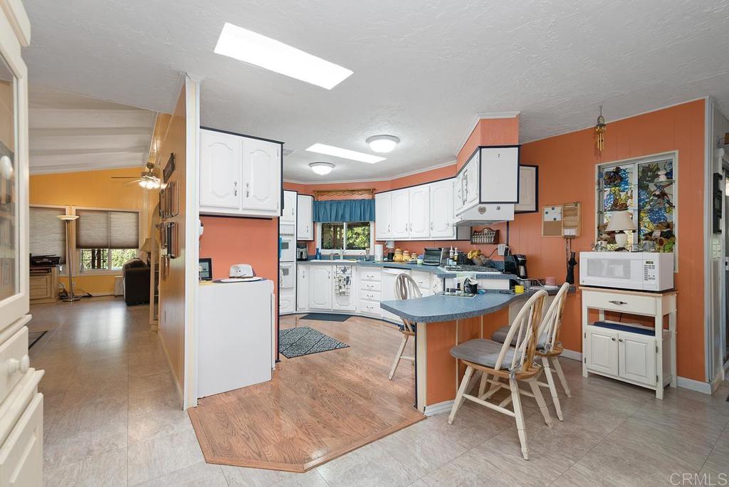 18218 Paradise Mountain Road Valley Center, CA 92082 - Photo 16 of 37 a kitchen with a sink a counter top stainless steel appliances and cabinets