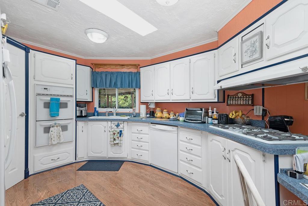 18218 Paradise Mountain Road Valley Center, CA 92082 - Photo 17 of 37 a kitchen with stainless steel appliances granite countertop a stove a sink and a refrigerator