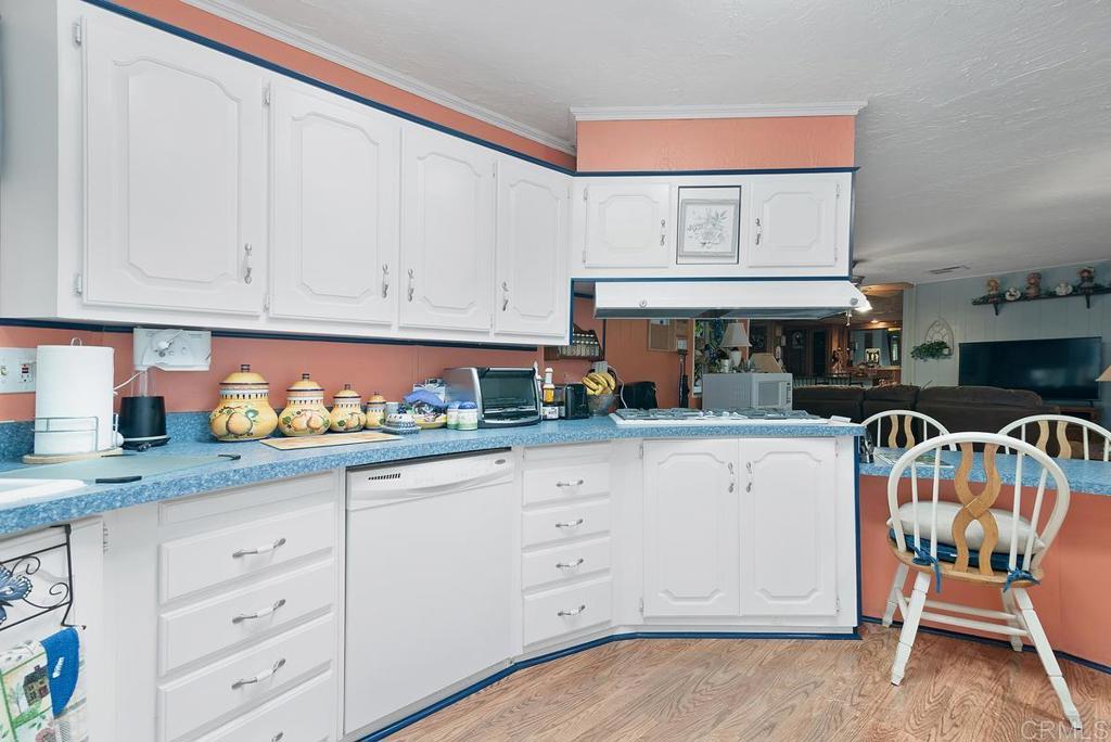 18218 Paradise Mountain Road Valley Center, CA 92082 - Photo 18 of 37 a kitchen with granite countertop white cabinets and white appliances