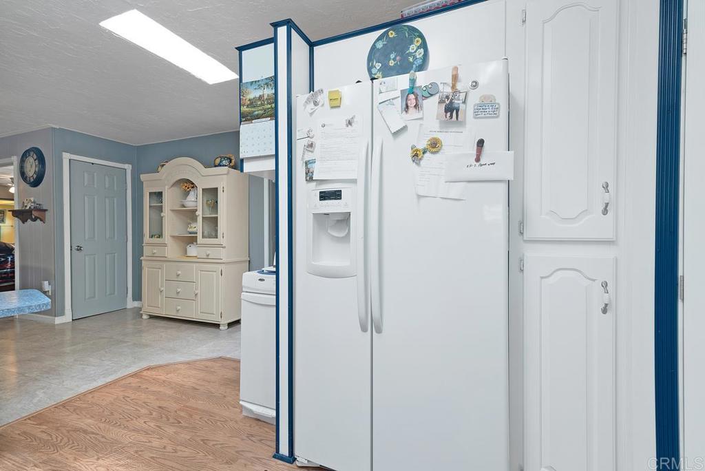 18218 Paradise Mountain Road Valley Center, CA 92082 - Photo 19 of 37 a kitchen with stainless steel appliances a refrigerator and cabinets