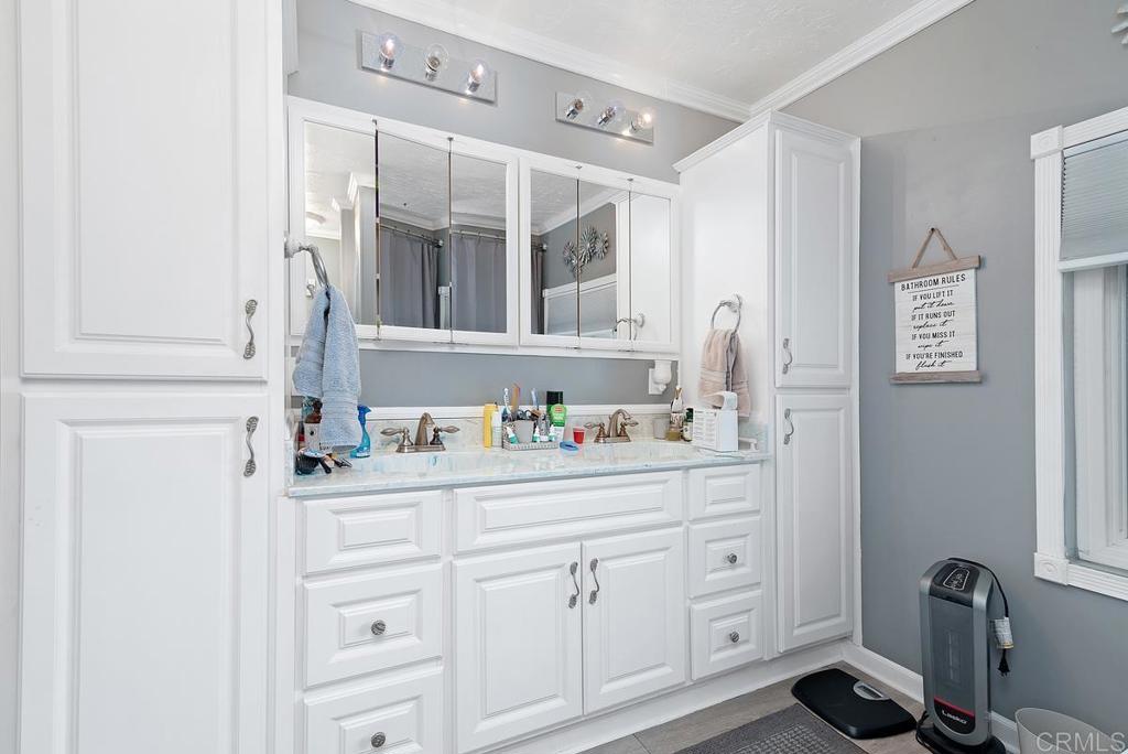 18218 Paradise Mountain Road Valley Center, CA 92082 - Photo 23 of 37 a bathroom with a sink and a mirror