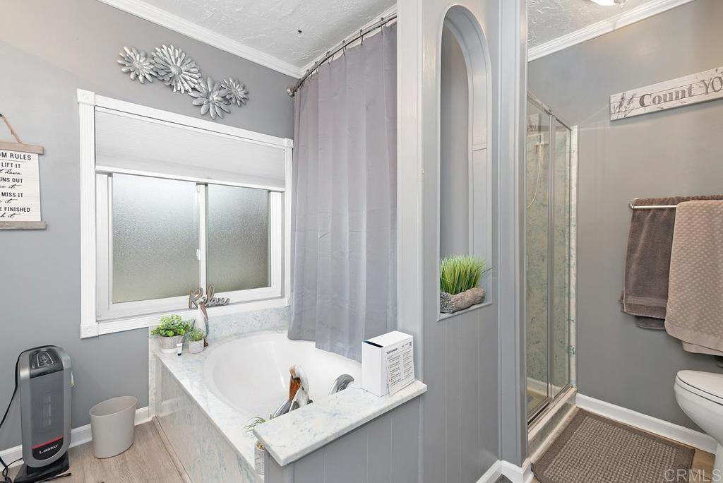 18218 Paradise Mountain Road Valley Center, CA 92082 - Photo 24 of 37 a bathroom with a sink a toilet and shower