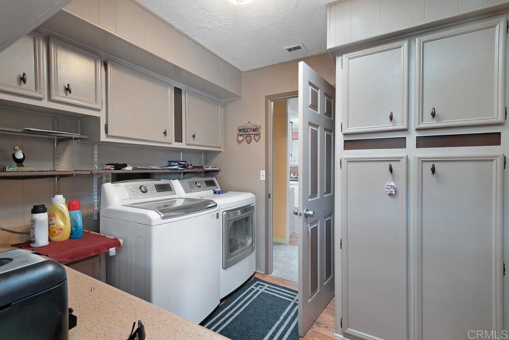 18218 Paradise Mountain Road Valley Center, CA 92082 - Photo 27 of 37 a view of storage and utility room with refrigerator and dishwasher