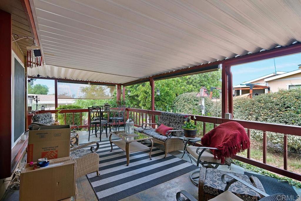 18218 Paradise Mountain Road Valley Center, CA 92082 - Photo 29 of 37 a view of a patio with table and chairs potted plants with wooden floor and fence