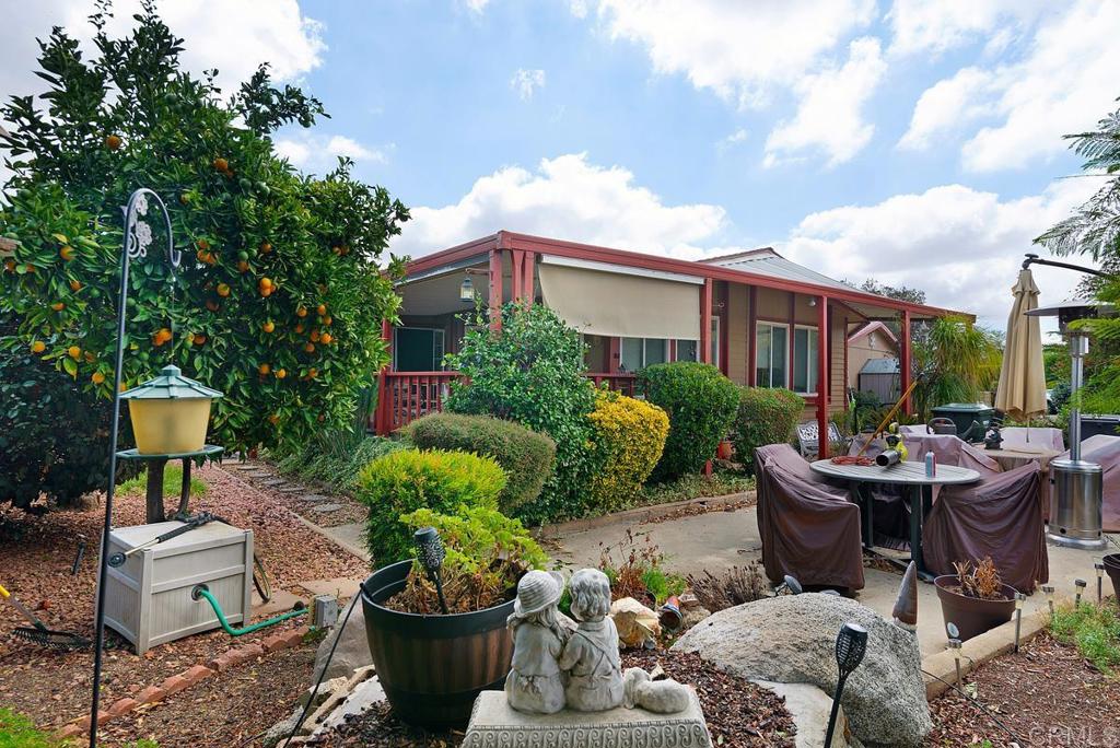 18218 Paradise Mountain Road Valley Center, CA 92082 - Photo 31 of 37 a view of a patio filled with furniture and a garden