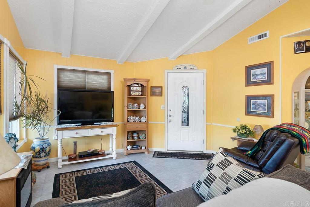 18218 Paradise Mountain Road Valley Center, CA 92082 - Photo 8 of 37 a living room with furniture and a flat screen tv