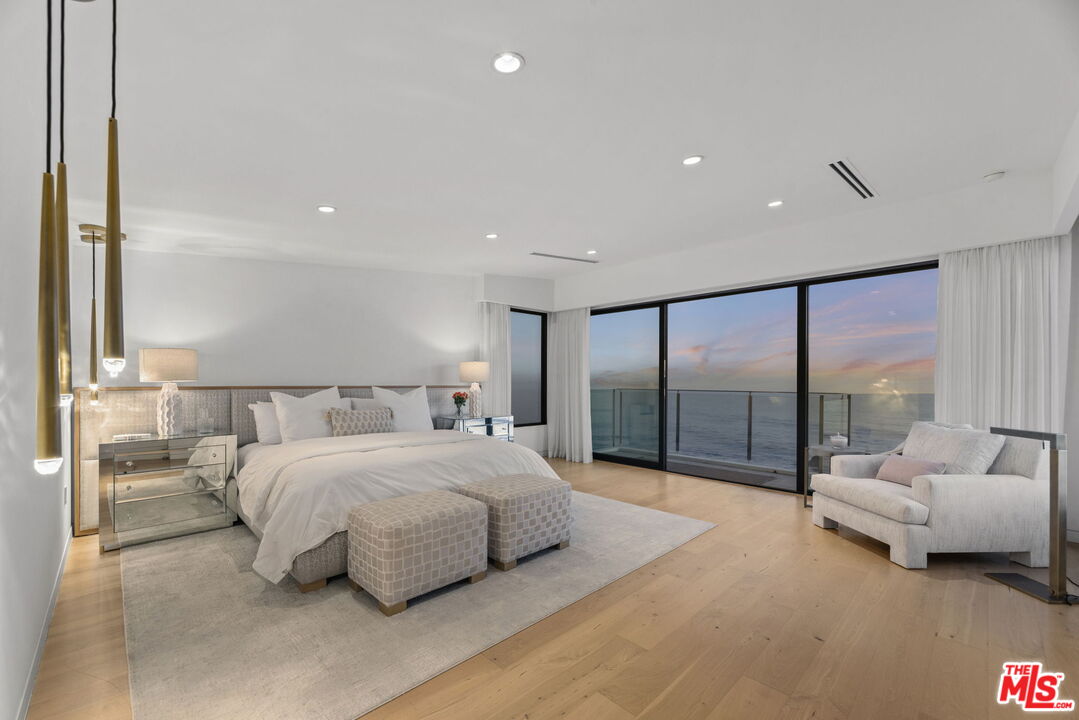 24146 Malibu Road Malibu, CA 90265 - Photo 11 of 25 a spacious bedroom with a bed and a large window