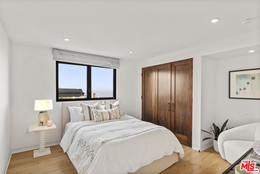 24146 Malibu Road Malibu, CA 90265 - Photo 15 of 25 a bedroom with a bed and a painting on the wall