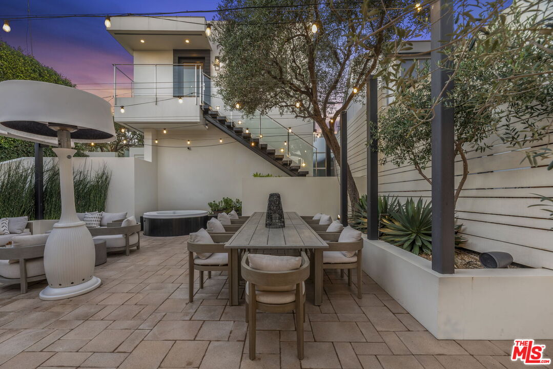 24146 Malibu Road Malibu, CA 90265 - Photo 18 of 25 a backyard of a house with table and chairs