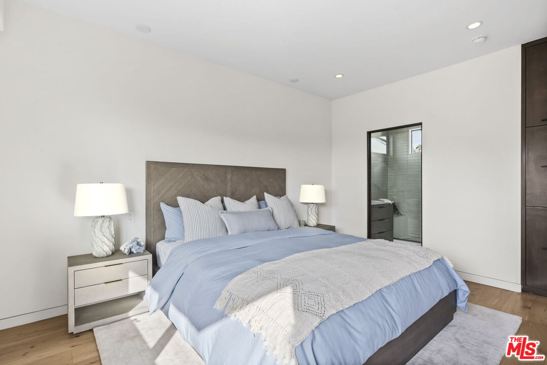 24146 Malibu Road Malibu, CA 90265 - Photo 20 of 25 a bedroom with a bed and a lamp