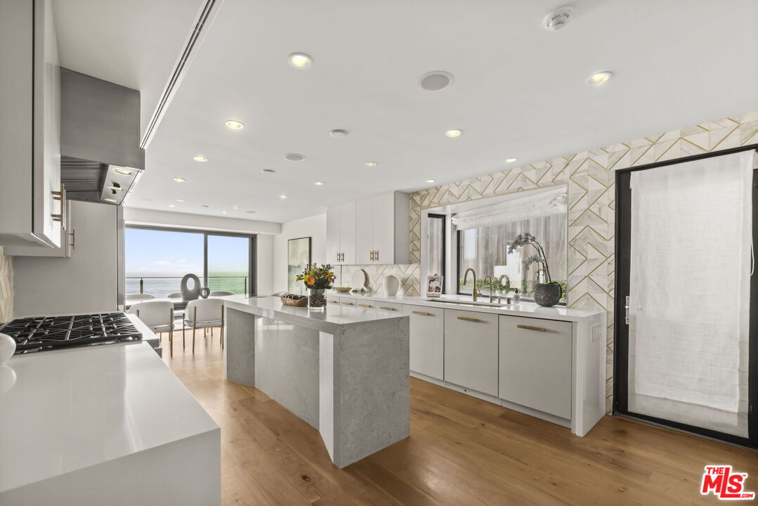24146 Malibu Road Malibu, CA 90265 - Photo 6 of 25 a kitchen with lots of counter top space and refrigerator