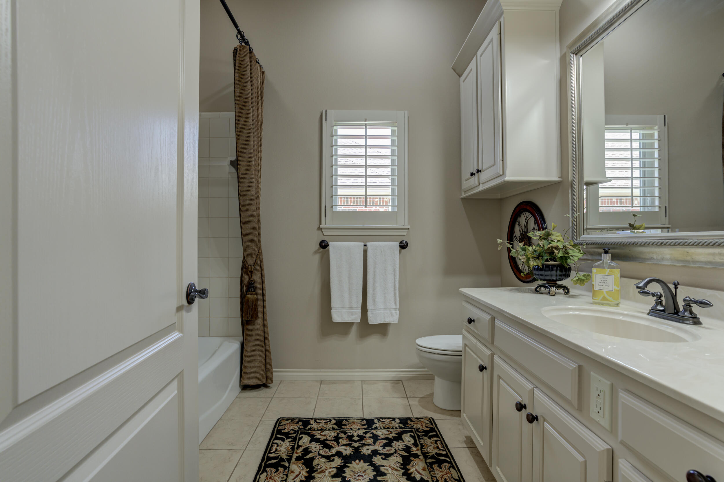 6008 89th Street Lubbock, TX 79424 - Photo 45 of 61 a bathroom with a sink a toilet and shower