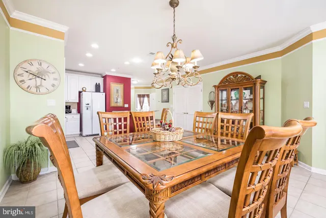 a living room with furniture a chandelier and a table