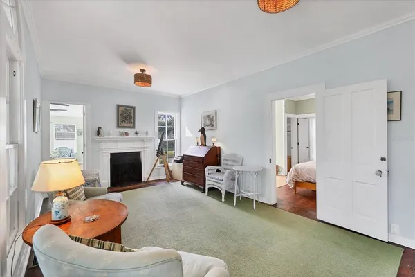 a living room with furniture a fireplace and a large window