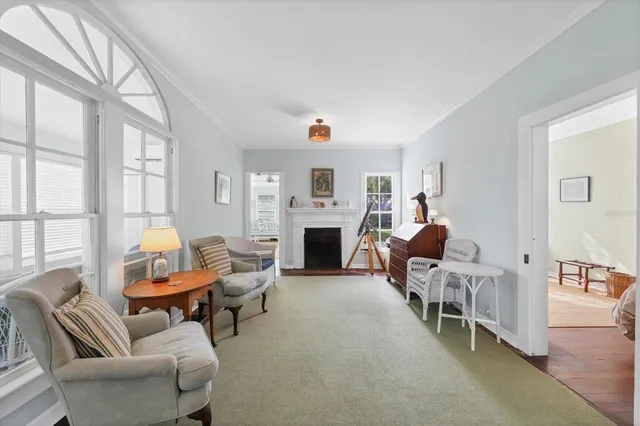 a living room with furniture and a dining table